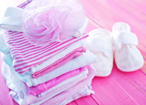 Baby clothes on the pink table — Stock Photo, Image