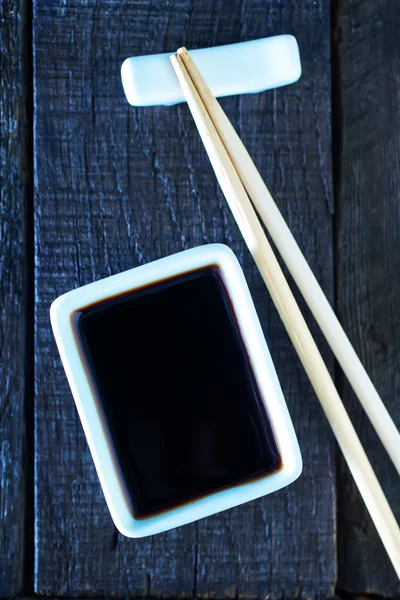 Soy sauce and bamboo sticks — Stock Photo, Image