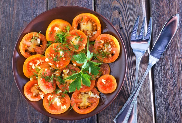 Yellow tomato with spice and oil — Stock Photo, Image