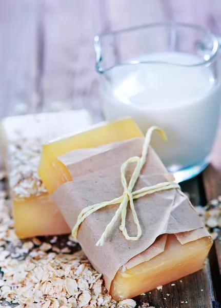 Oatmeal soap and milk in jug — Stock Photo, Image