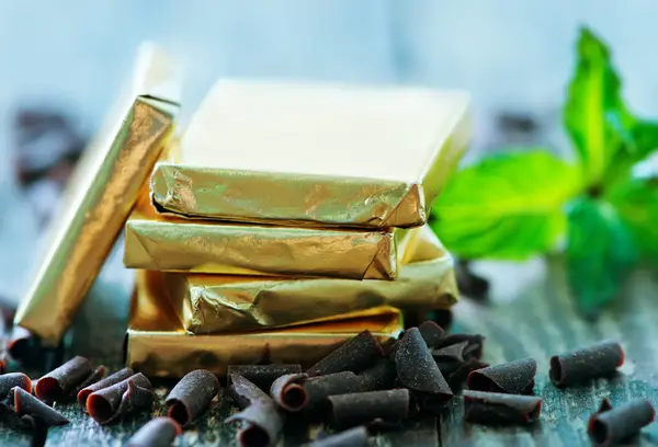 Chocolate candy with mint leaf — Stock Photo, Image