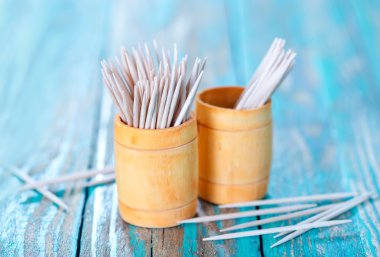 Wooden toothpicks on the green table clipart