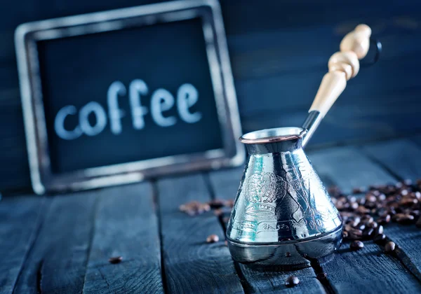 Coffee beans on the wooden table — Stock Photo, Image