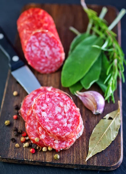 Fresh salami and knife — Stock Photo, Image