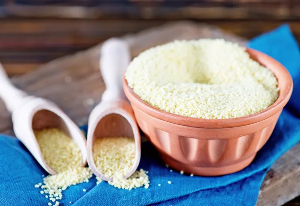 Cous-cous in bowl and on a table — Stock Image Cous-cous in bowl and on a table Royalty Free Stock Photos