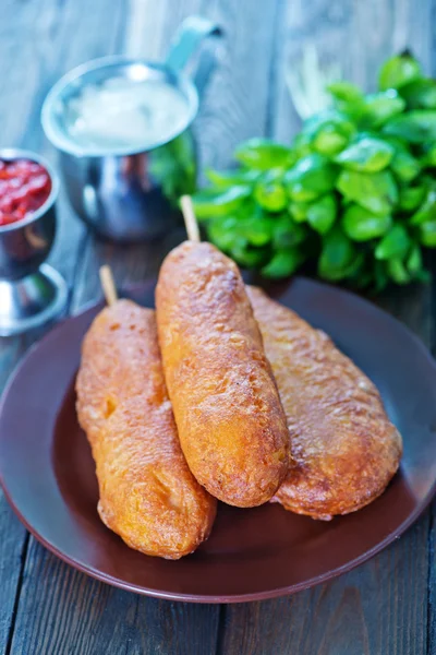 Fresh corndogs on plate — Stock Photo, Image