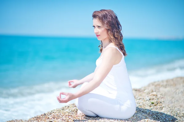 Young woman meditating on the beach — Stock Photo, Image