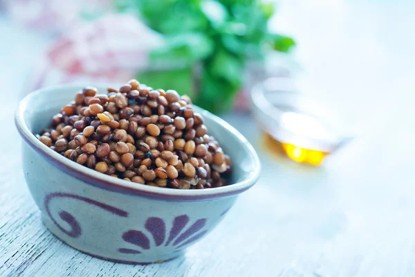 Lentil in bowl with olive oil — Stock Photo, Image