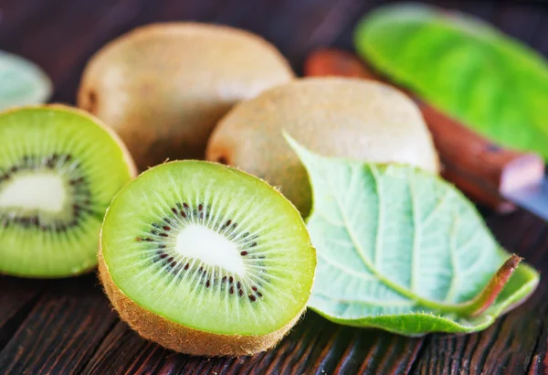 Fresh kiwi on wooden background — Stock Photo, Image