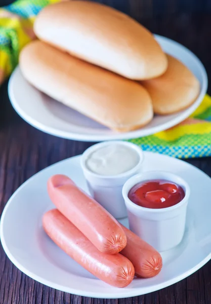 Buns and sausages with sauces — Stock Photo, Image