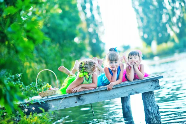 Cute sisters on pier — Stock Photo, Image