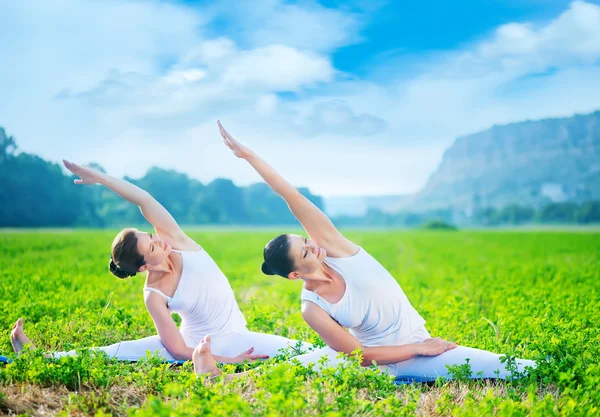 Women practicing yoga in field — Stock Photo, Image