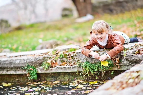 Girl playing  in  autumn park — Stock Photo, Image