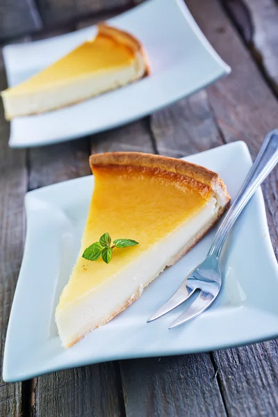 Cheesecake and fork on  plate — Stock Photo, Image