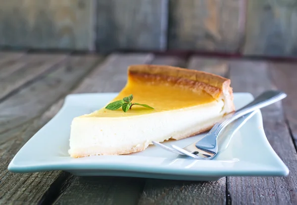 Cheesecake and fork on  plate — Stock Photo, Image