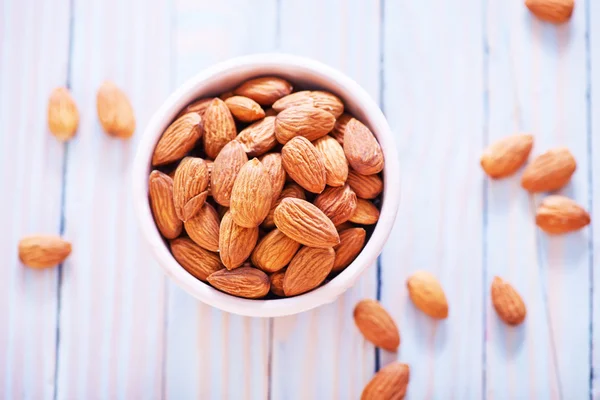 Almonds in pink bowl — Stock Photo, Image