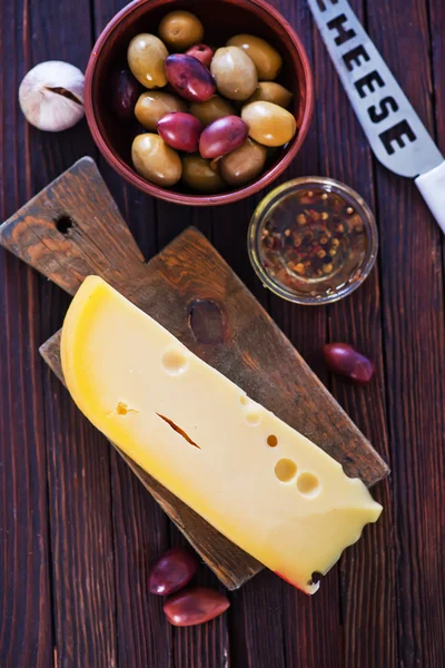 Piece of cheese with olives — Stock Photo, Image