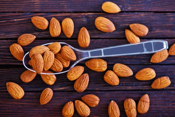 Dry almonds in spoon — Stock Photo, Image