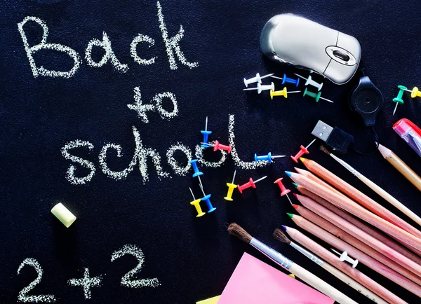 School supplies and blackboard — Stock Photo, Image