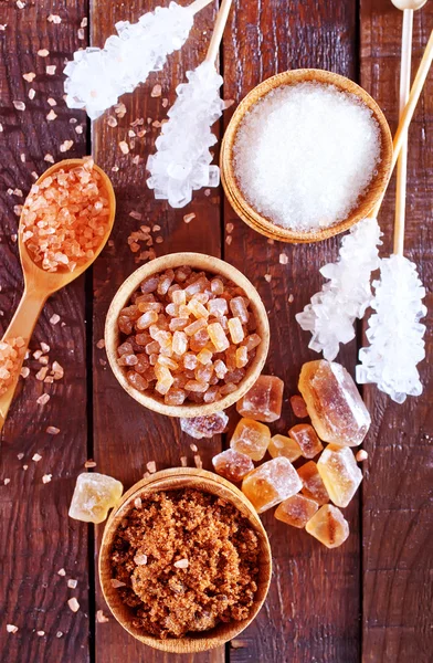 Sugar in the bowl and on a table — Stock Photo, Image