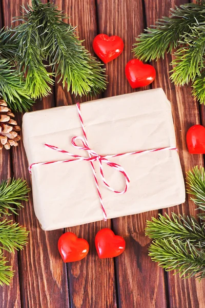 Present with ribbon and decorations — Stock Photo, Image