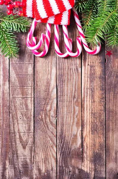 Candy canes, fir tree branches — Stock Photo, Image