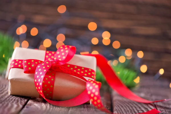 Present with red ribbon — Stock Photo, Image