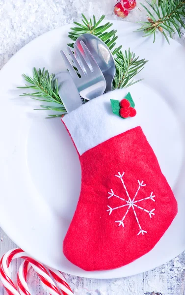 Cutlery on plate and decorations — Stock Photo, Image