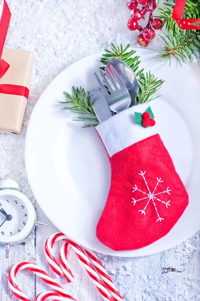 Cutlery on plate and decorations — Stock Photo, Image