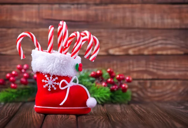 Christmas candy canes in boot — Stockfoto