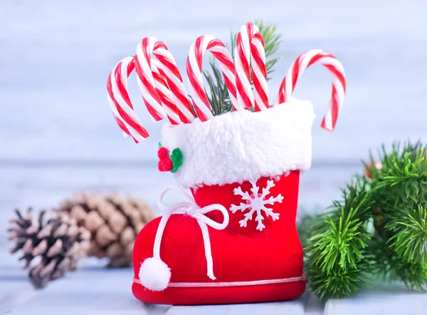 Christmas candy canes in boot — Stockfoto