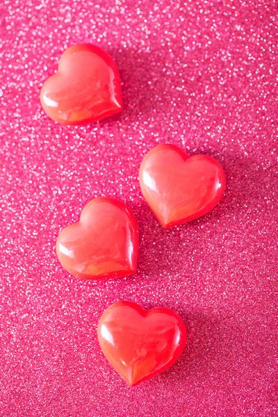 Red hearts on red paper — Stock Photo, Image