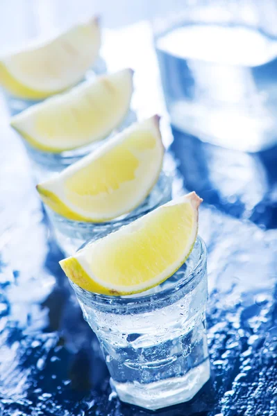 Tequilla with limes in glasses — Stock Photo, Image
