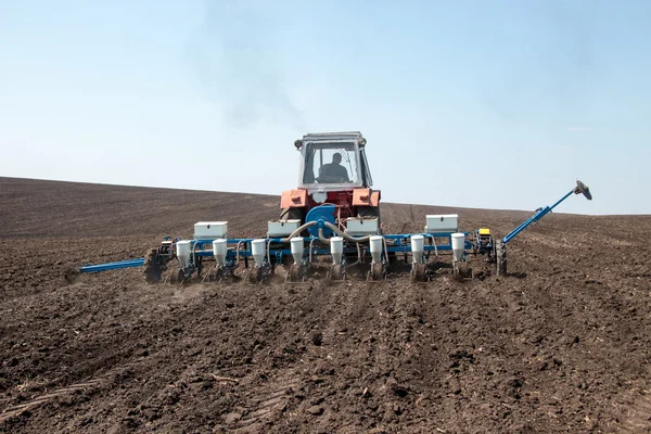 Tractor with sower on the field — Stock Photo, Image