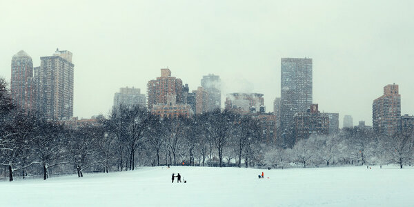 Central Park winter in snow with skyscrapers in midtown Manhattan New York City