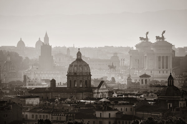 Rome rooftop view at sunrise silhouette black and white with ancient architecture in Italy.