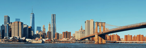 Manhattan financial district with skyscrapers and Brooklyn Bridge.