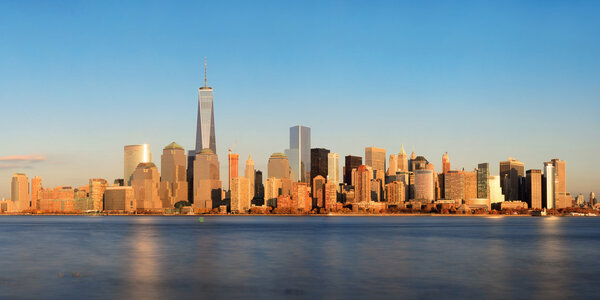 New York City skyline panorama with skyscrapers over Hudson River at sunset viewed from New Jersey