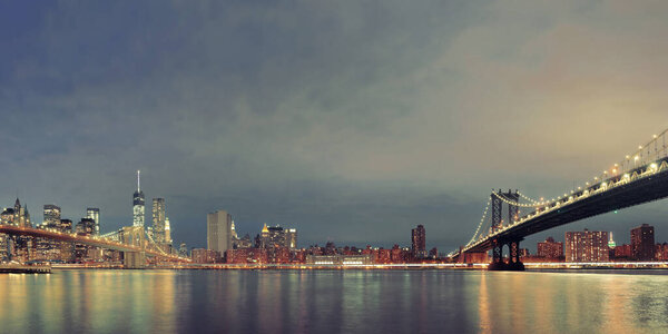 Manhattan Downtown urban view with Brooklyn bridge at night