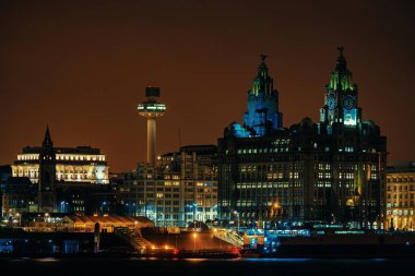 Liverpool Royal Liver Building at night with buildings in England in United Kingdom clipart