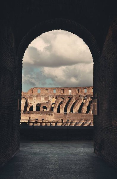 Archway in Colosseum, the world known landmark and the symbol of Rome, Italy.