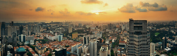 Singapore rooftop view with urban skyscrapers at sunset.