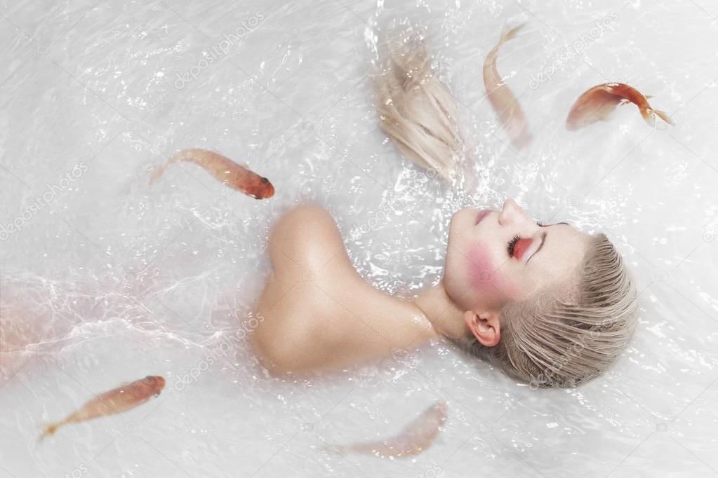 portrait of beautiful mermaid girl with fish tail and long blond hair swimming in ocean magic mythology being original photo com