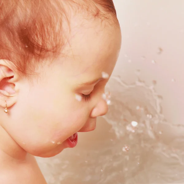 Little baby girl washing her face in the bathroom — Stock Photo, Image