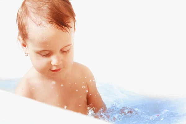 Beautiful baby girl playing with water in the bath — Stock Photo, Image