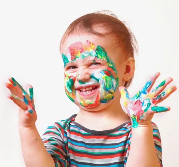 Happy cute smiling little girl with colorful painted hands