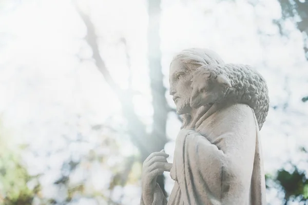 Antique statue of Jesus Christ Good Shepherd. In the Christian tradition, a symbol of human importance to God. Horizontal image.