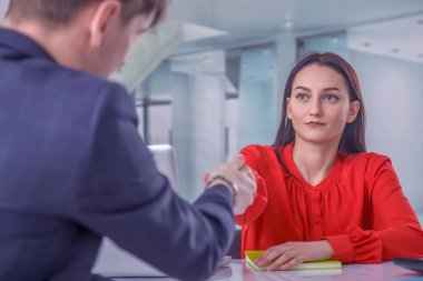 Business, new job, interview the job and hiring concept. Job applicant greets and makes handshake with new male employee. Horizontal image.