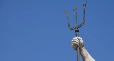 Trident as a symbol of the power of the god of the seas and oceans Neptune (Poseidon, Triton). Copy space for design or text.