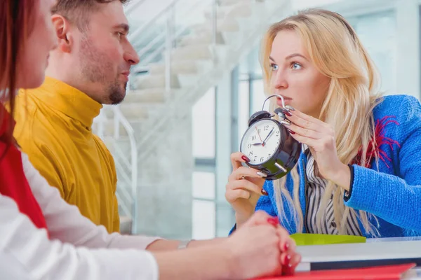 Furious female company director receiving reprimand from boss for being too late at meeting.